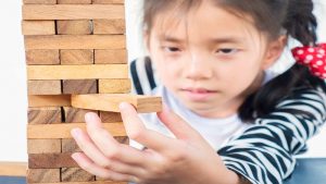 asian-kid-is-playing-jenga-wood-blocks-tower-game-practicing-physical-mental-skill_800x450